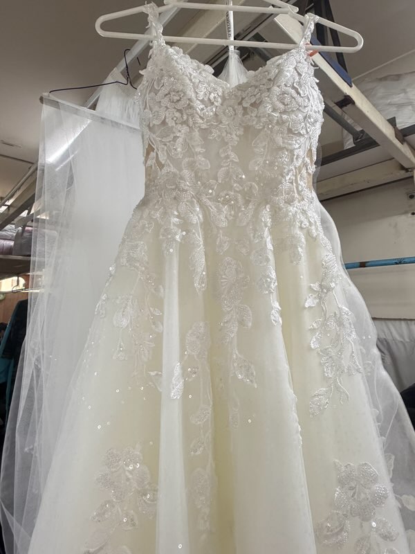 A white suit jacket received with stains, ready for restoration