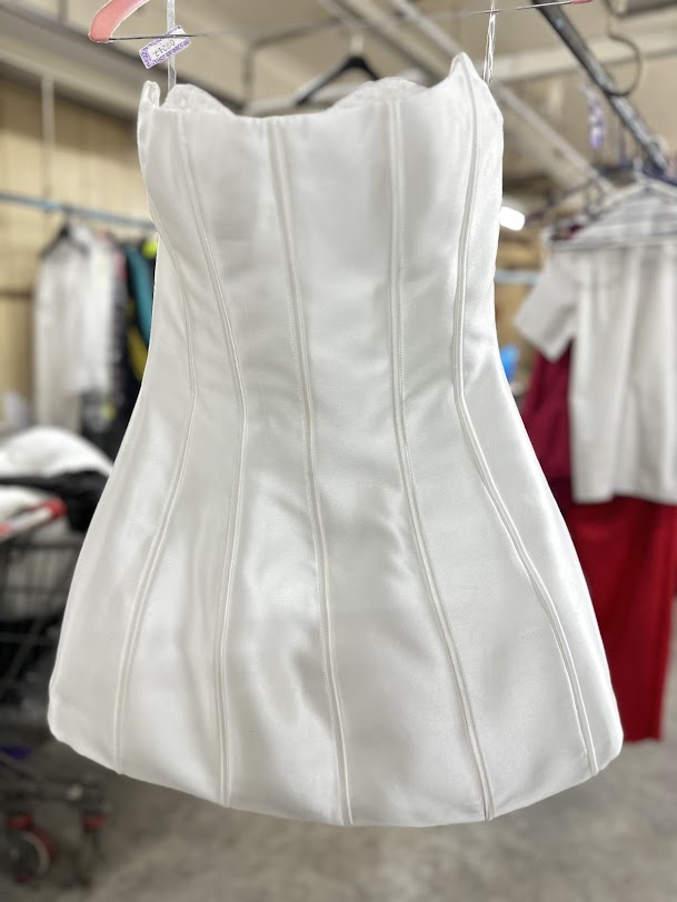 A white suit with stubborn stains brought in for restoration